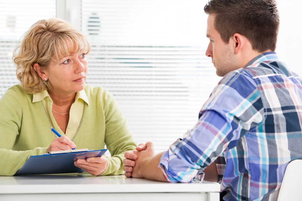 addiction treatment provider helping a patient