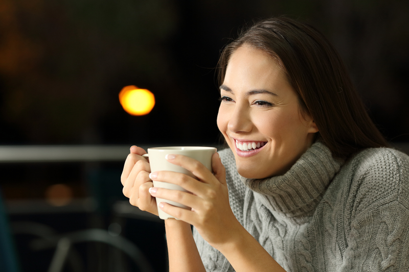 Happy woman holding coffee cup, self-love in recovery on valentine's day