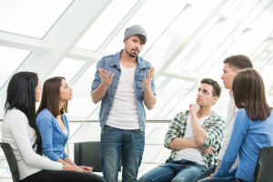 AA meeting with one person addressing the group, terminally unique, AA groupthink