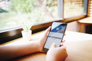 person opening the facebook app with their cellphone