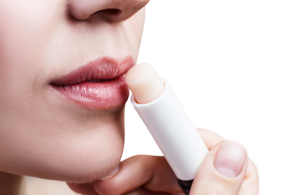 woman applying lip balm