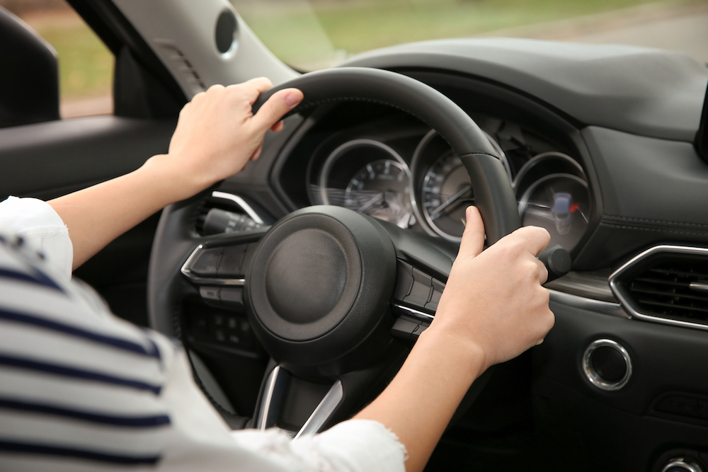 woman holding a steering wheel