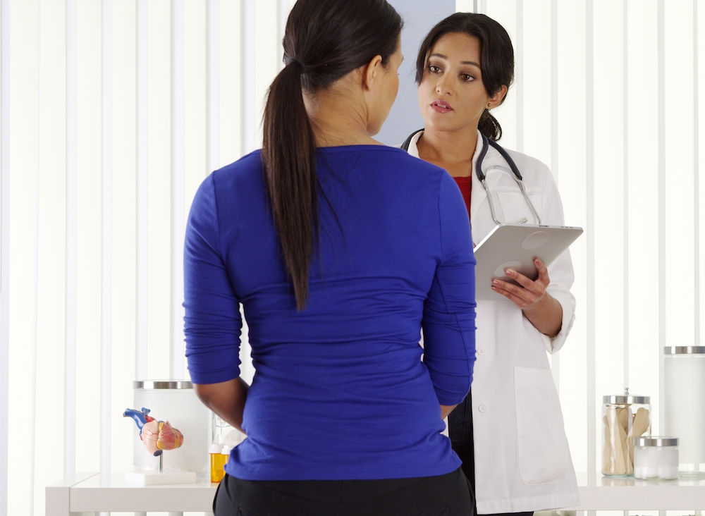 woman being diagnosed with syphilis by her OBGYN