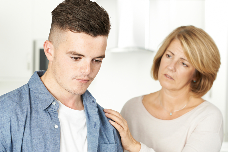 Troubled mother and teen son, wondering about teen rehab for drug treatment