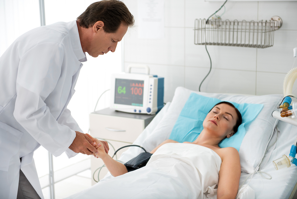 doctor checking on woman in deep coma for depression treatment