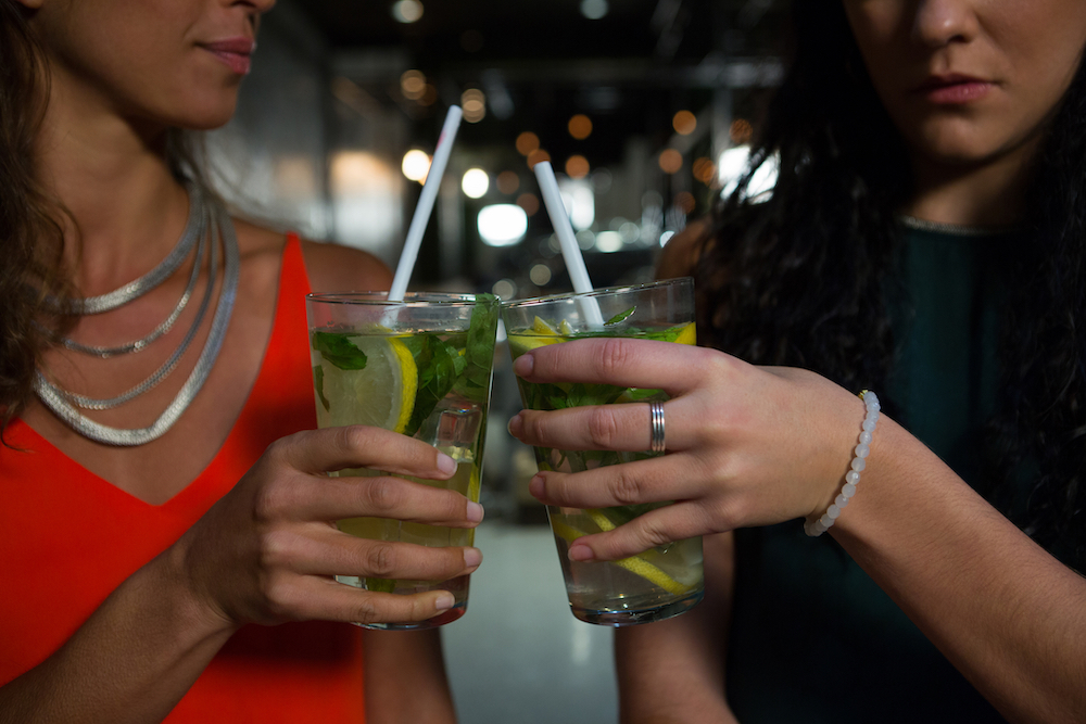 women toasting with cocktails at a sober bar.