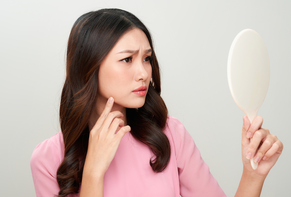 woman looking at mirror
