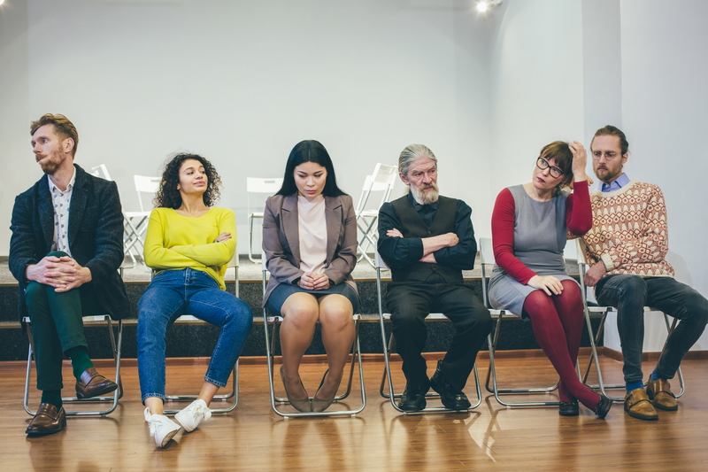 A group of people in an AA meeting, concerned that 12-step programs need to evolve and accept scientific advancements.