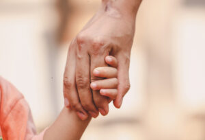 holding child's hand