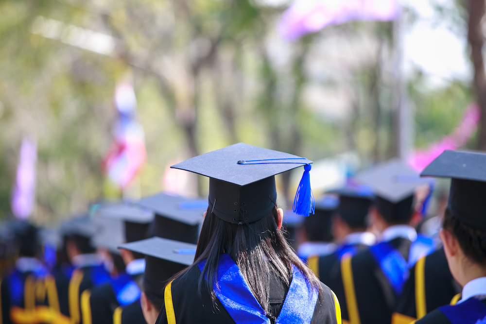 high school valedictorian sitting with fellow classmates