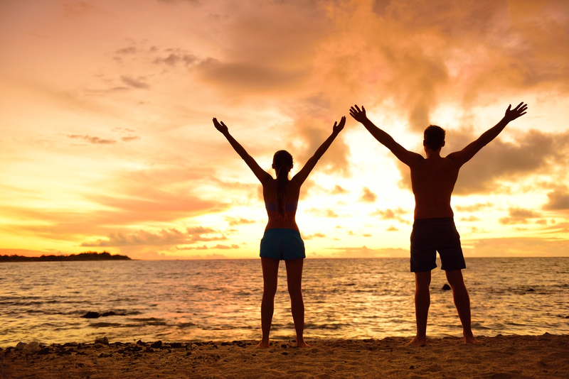 happy couple on beach integrating recovery into their lives