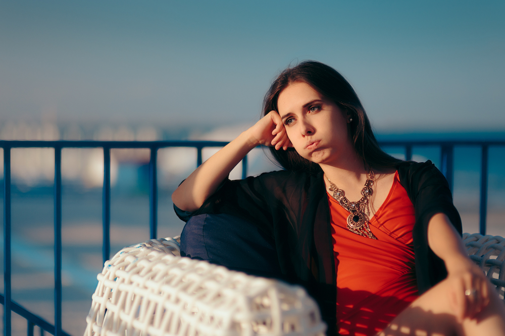 Woman with summertime blues sitting in the sun