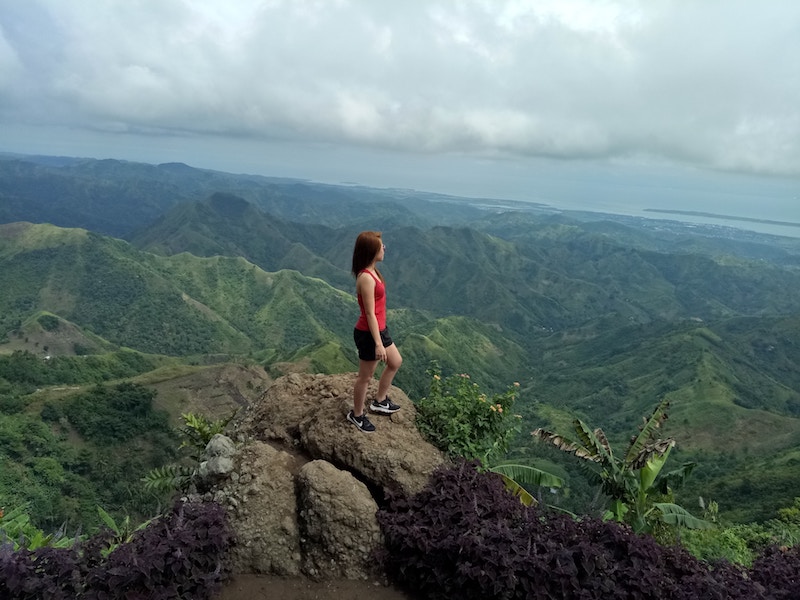 strong woman standing on a mountain