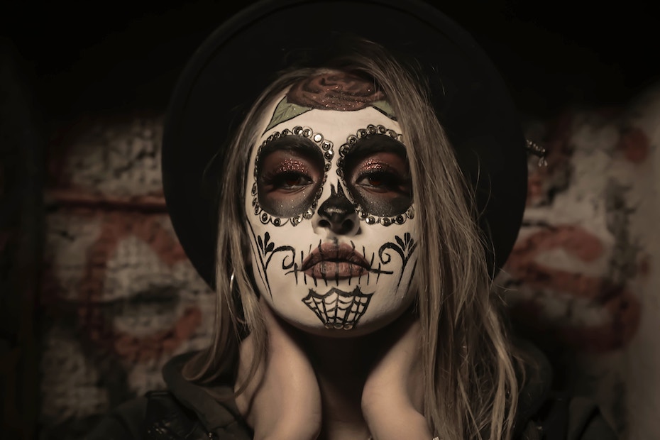Woman in sugar skull makeup, concept of deception, hidden truth, depression.