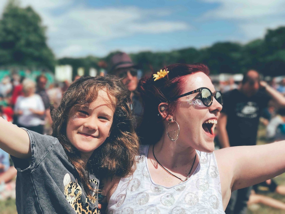 joyful woman at festival with her happy teenager