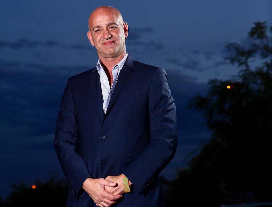 Justin Hoffman standing with hands clasped