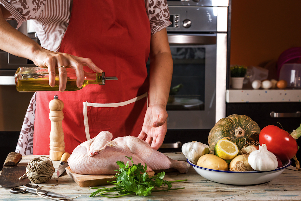 woman preparing chicken lunches for the recovery community