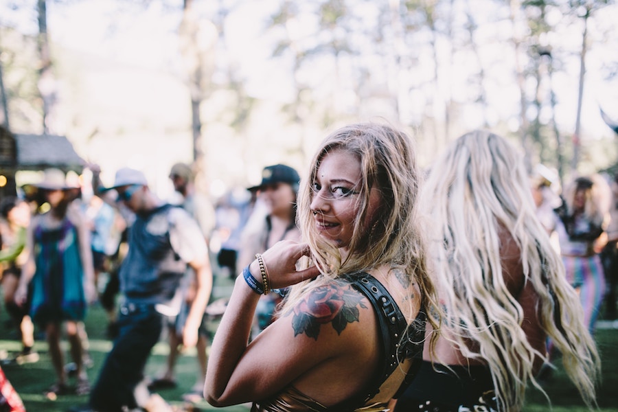 sober woman at festival smiling over her shoulder