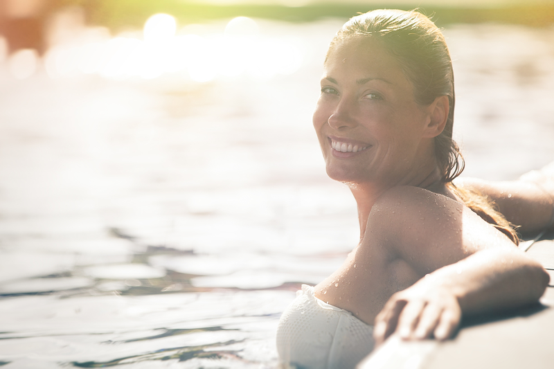 woman in a lake enjoying summer sunshine sober