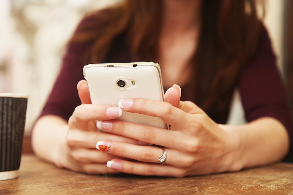 person with social media addiction using cellphone