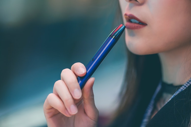 close up of teen girl vaping