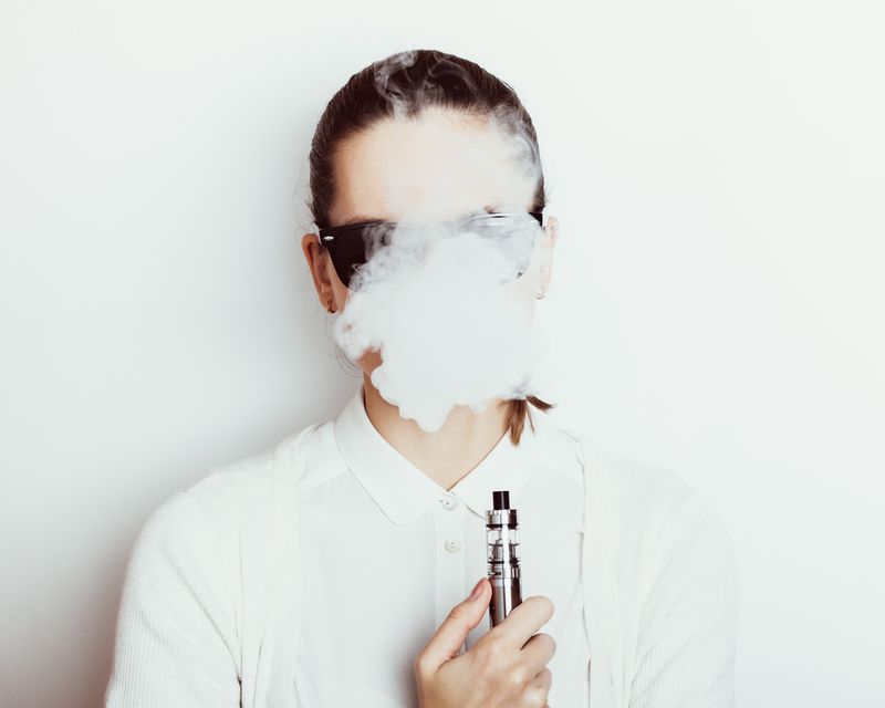 woman in sunglasses vaping