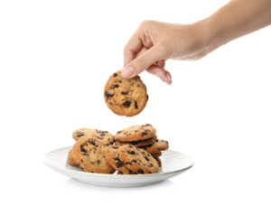 hand taking a chocolate chip cookie