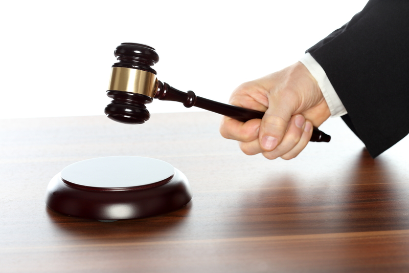 close-up of judges hand holding gavel