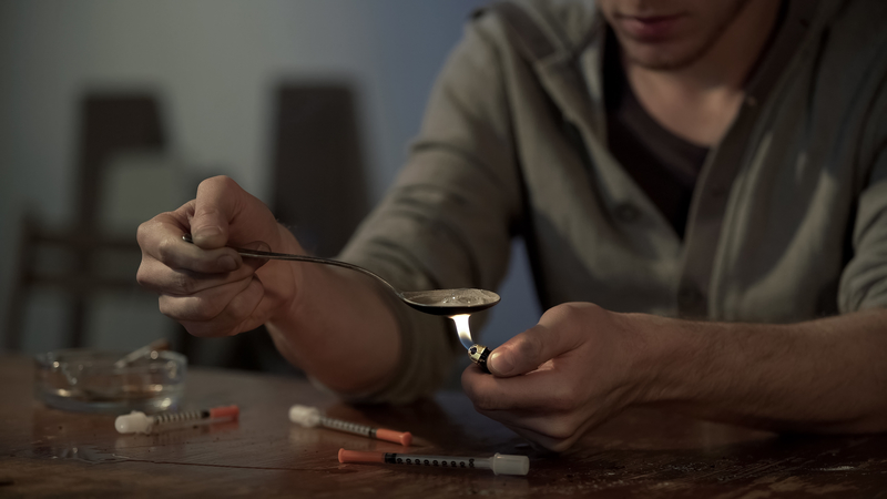 male addict using safe injection site