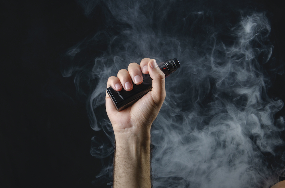 man holding vaping device