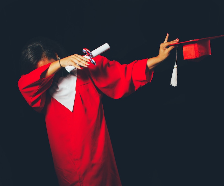 woman in red graduation robe, dabbing