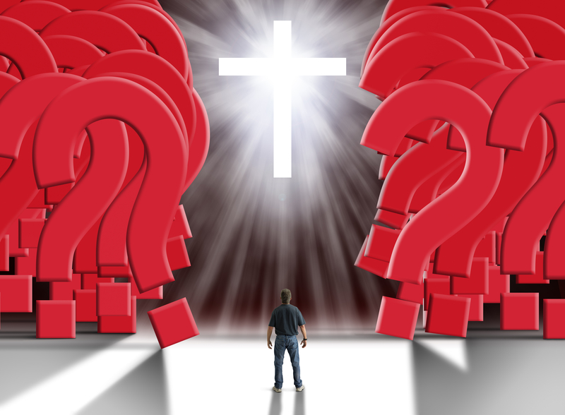 Man standing in front of glowing cross with flowing light beams parting a giant wall of huge red question marks
