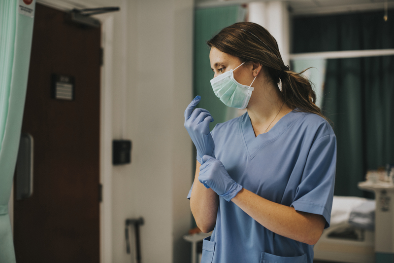 Woman wears medical mask and gloves