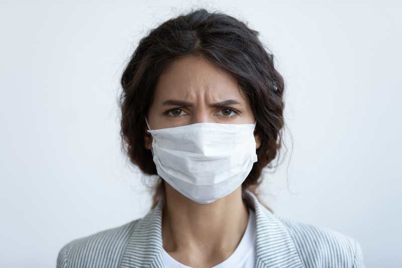 Angry faced woman wearing surgical mask