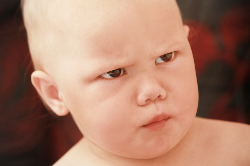 Baby with mad expression on face
