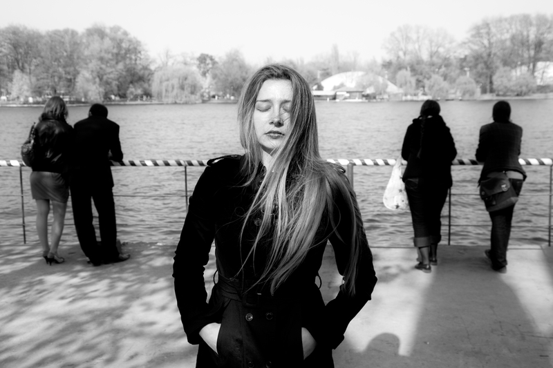 Isolated woman in black and white picture, people in background