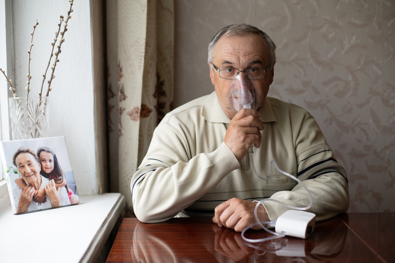Man with nebulizer or oxygen mask