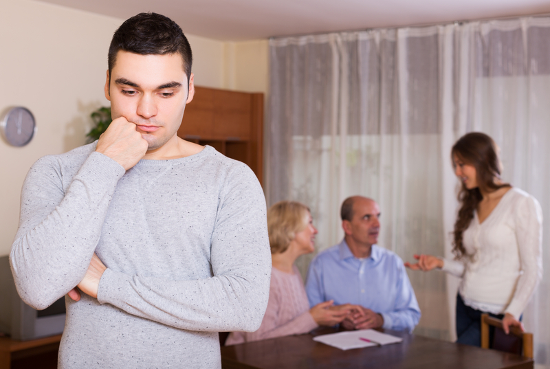 man separated from family, sad or pensive
