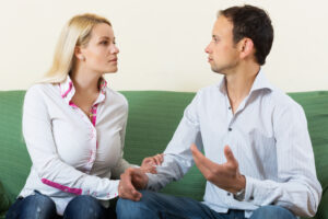 Hard Conversations: Talking With a Loved One About Their Drinking A woman and a man in conversation, her hand on his arm, serious